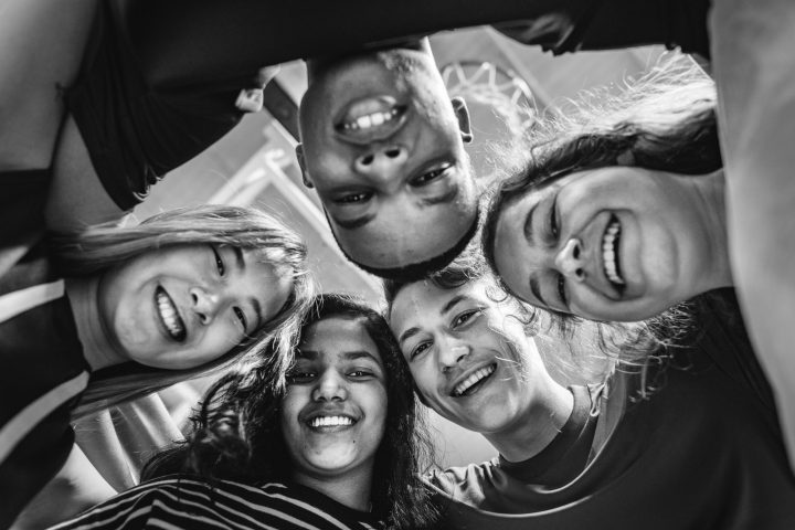 Group of teenager friends on a basketball court